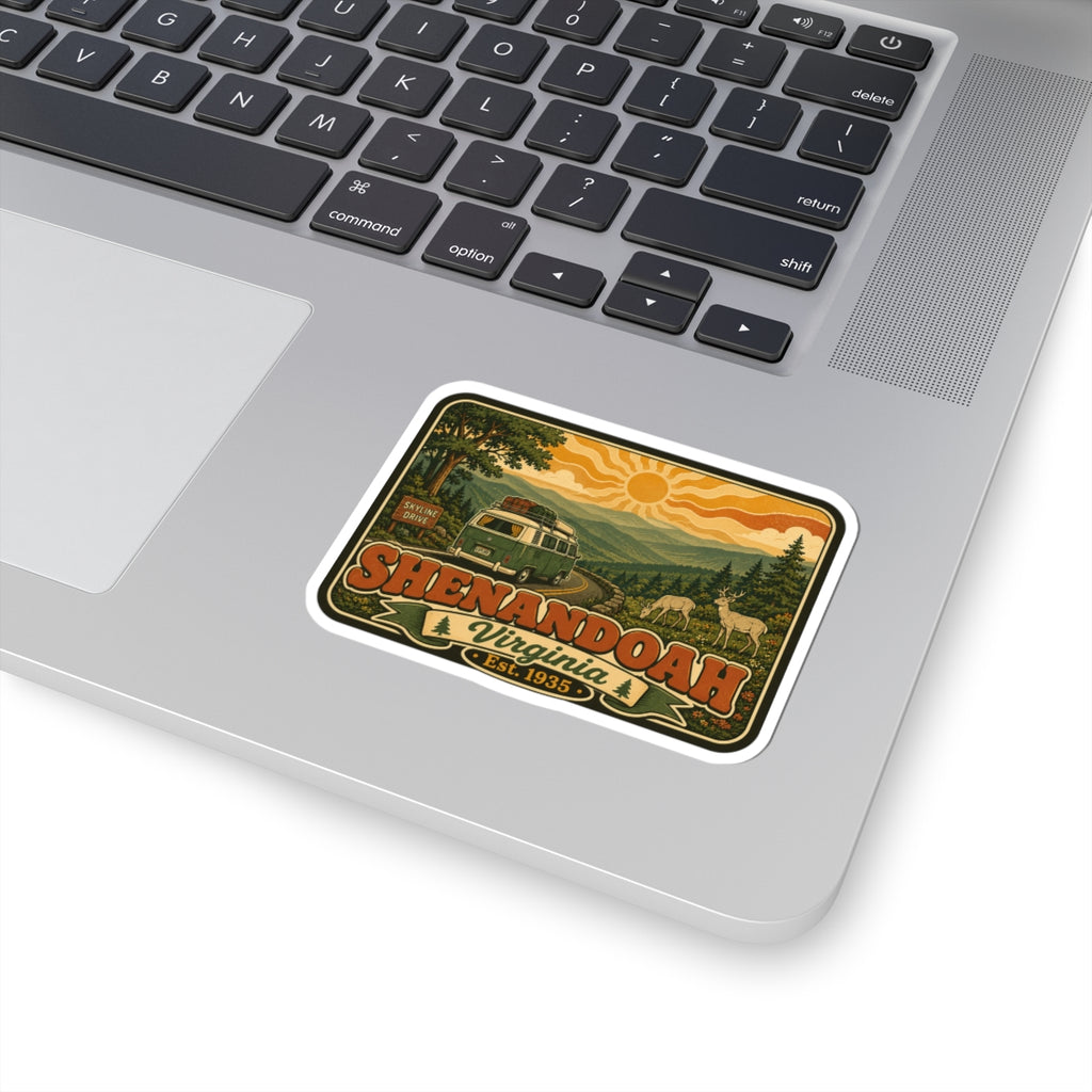 Kiss-cut sticker on a laptop keyboard: rounded border with retro camper, trees, and "Shenandoah Virginia"