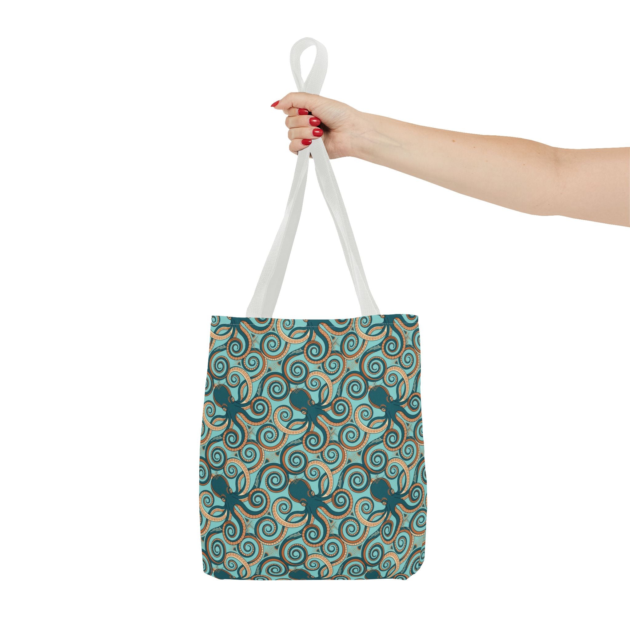 Octopus swirl tote bag held overhead by white handles; teal octopus swirl print.
