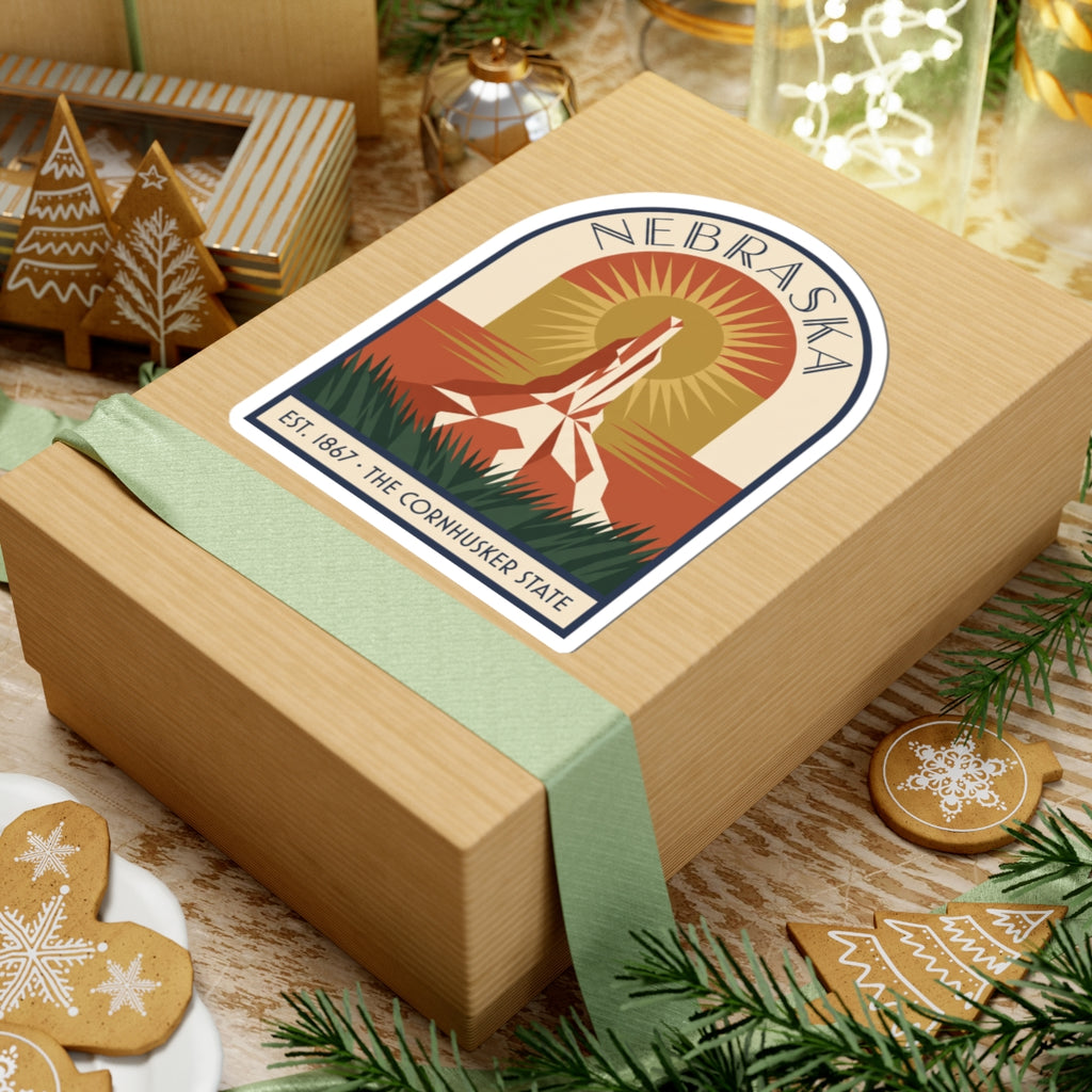 Nebraska vintage arch sticker on tan gift box with green ribbon and ornaments