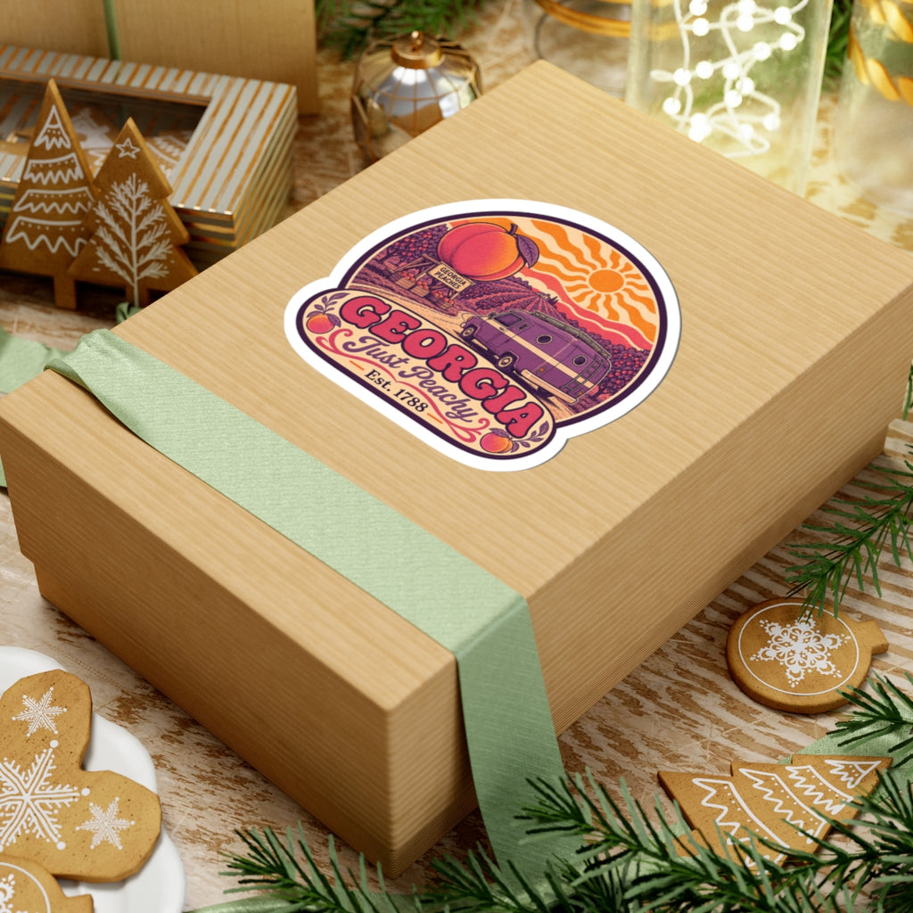 Georgia Just Peachy die-cut sticker on wrapped box, peach and sun over retro purple van, Est. 1788