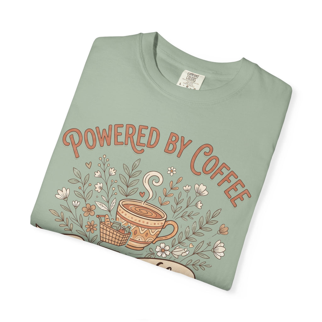 Green T-shirt with 'Powered by Coffee' graphic, floral leaves and coffee cup illustration