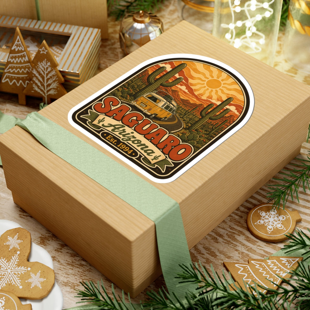 Saguaro Arizona kiss-cut sticker on a wrapped gift box, featuring camper van and Est. 1994