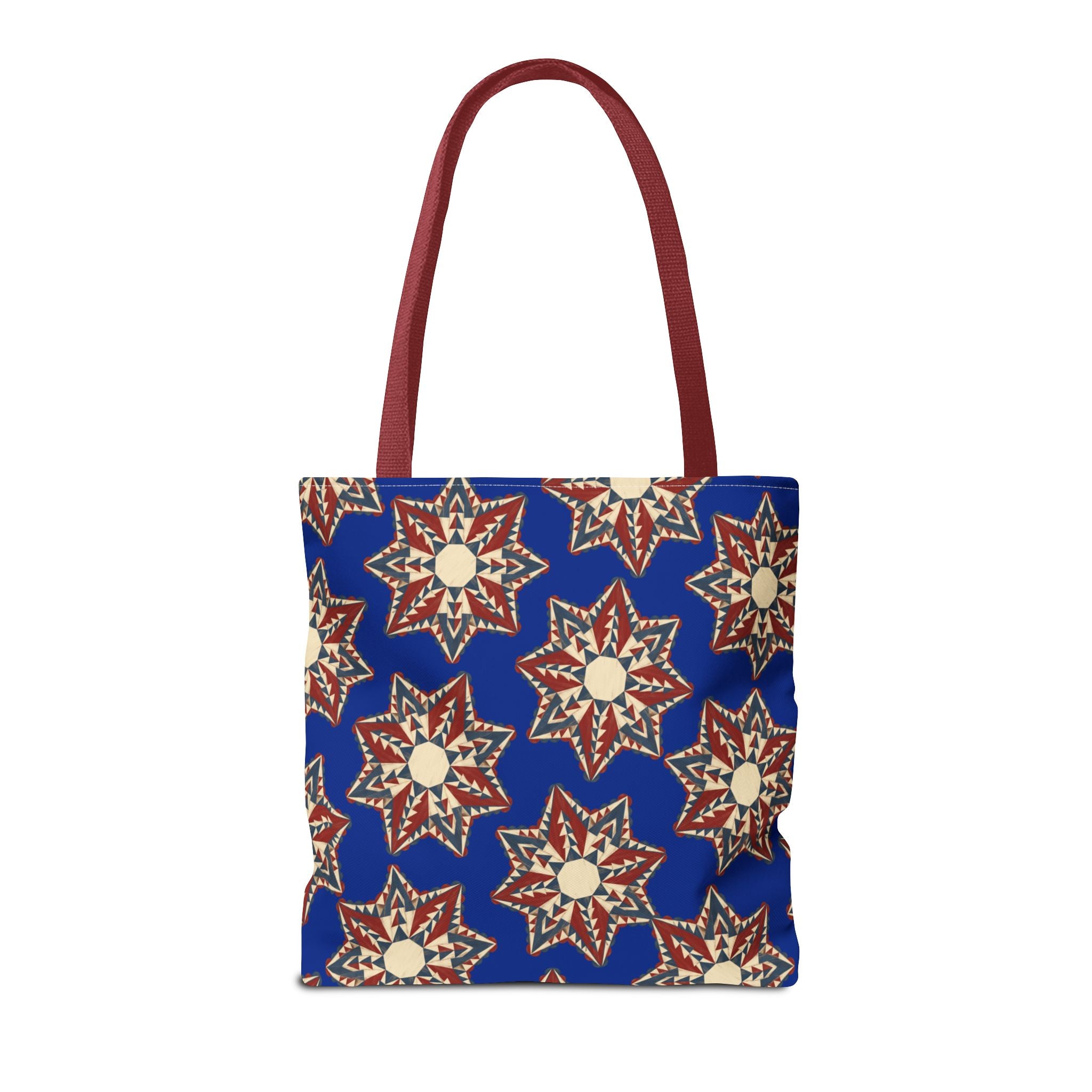Blue tote bag with starburst floral pattern and red handles
