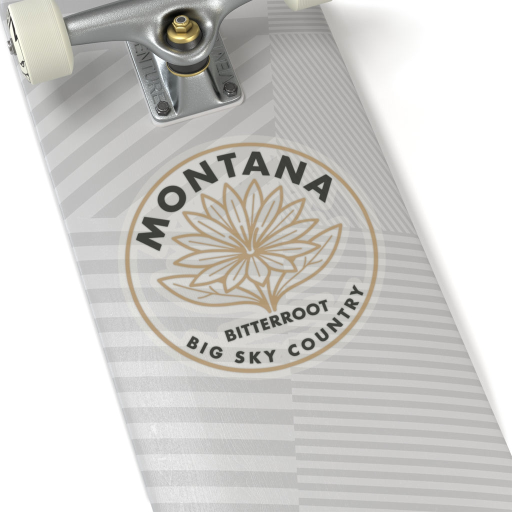Round transparent vinyl decal with “MONTANA,” “BITTERROOT,” and flower outline on striped surface