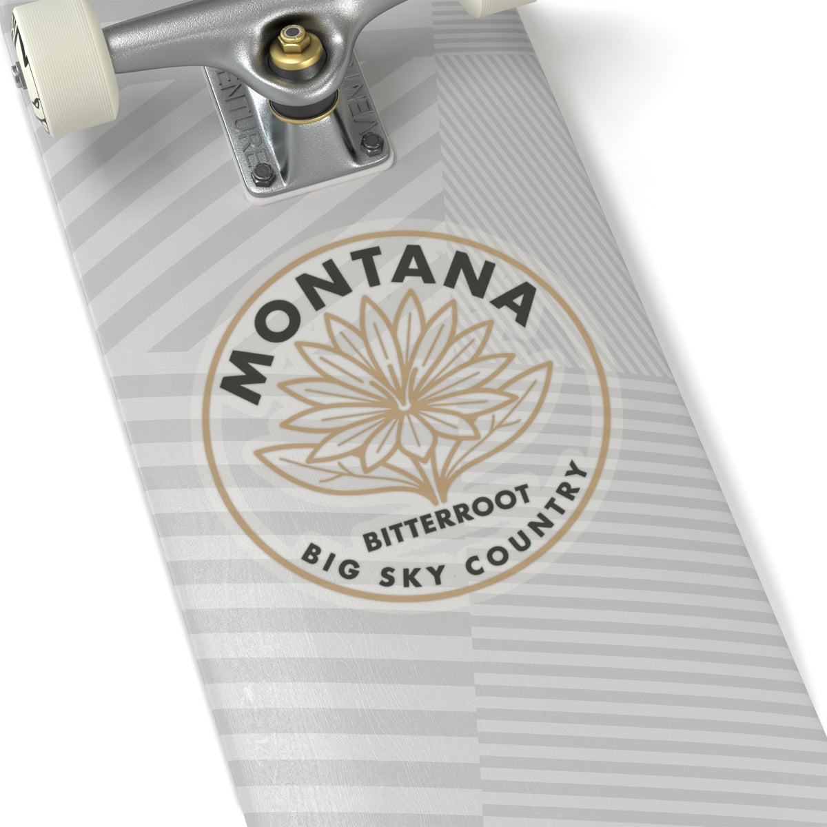 Round transparent vinyl decal with “MONTANA,” “BITTERROOT,” and flower outline on striped surface