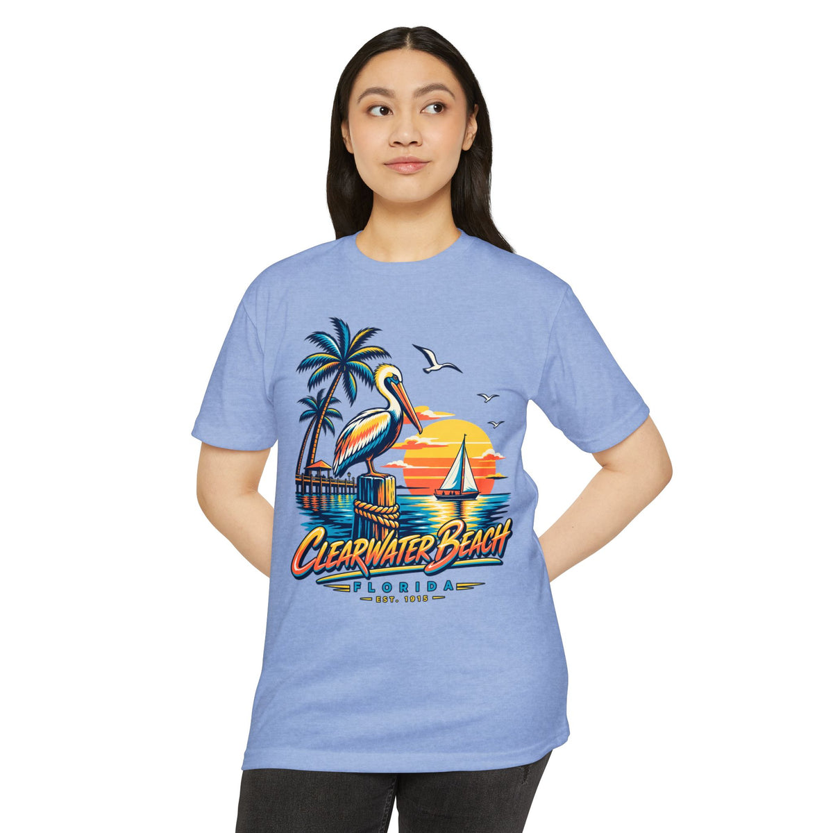 Blue T-shirt with pelican, palm trees, sailboat sunset graphic.