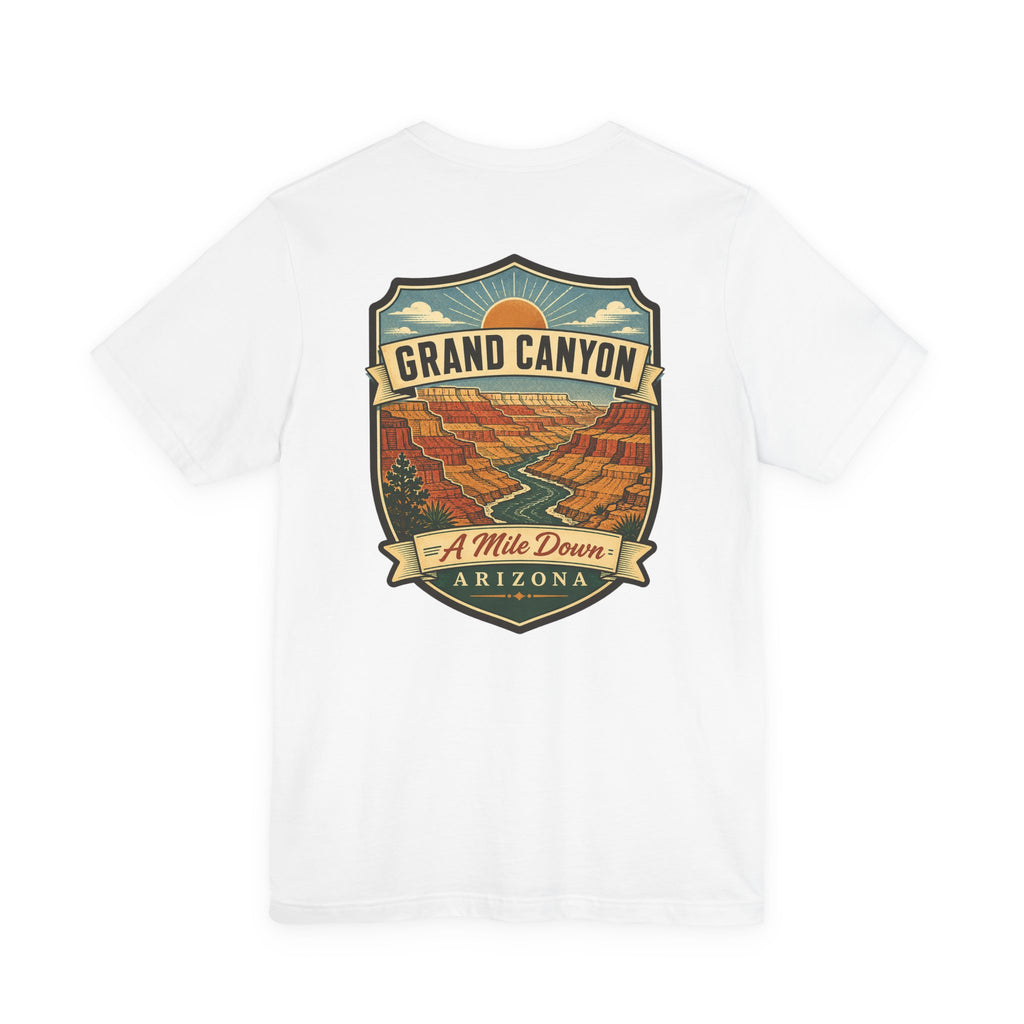 White crew-neck T-shirt with large Grand Canyon scenic badge graphic reading "A Mile Down"
