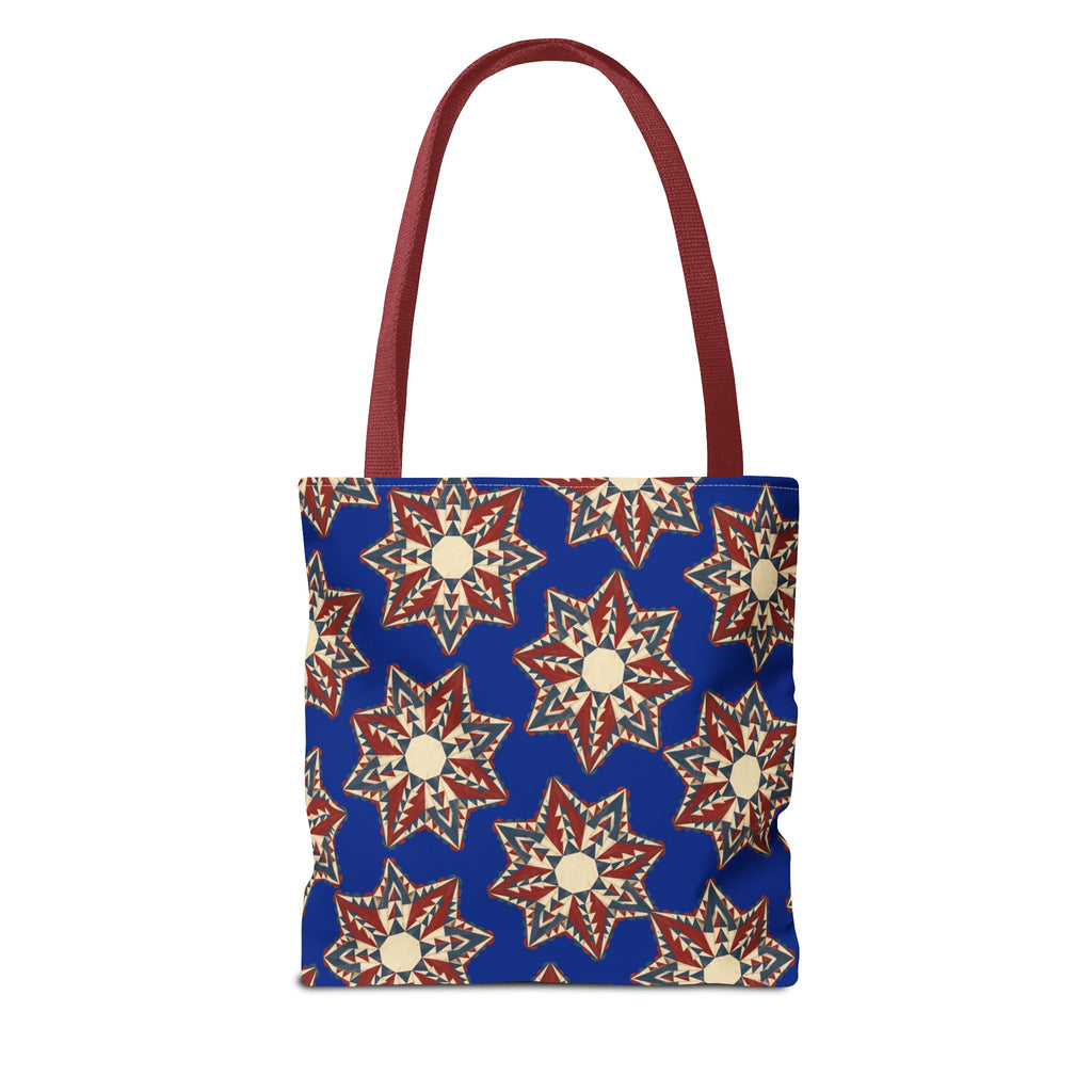 Blue tote bag with red and cream starburst floral pattern, red handles