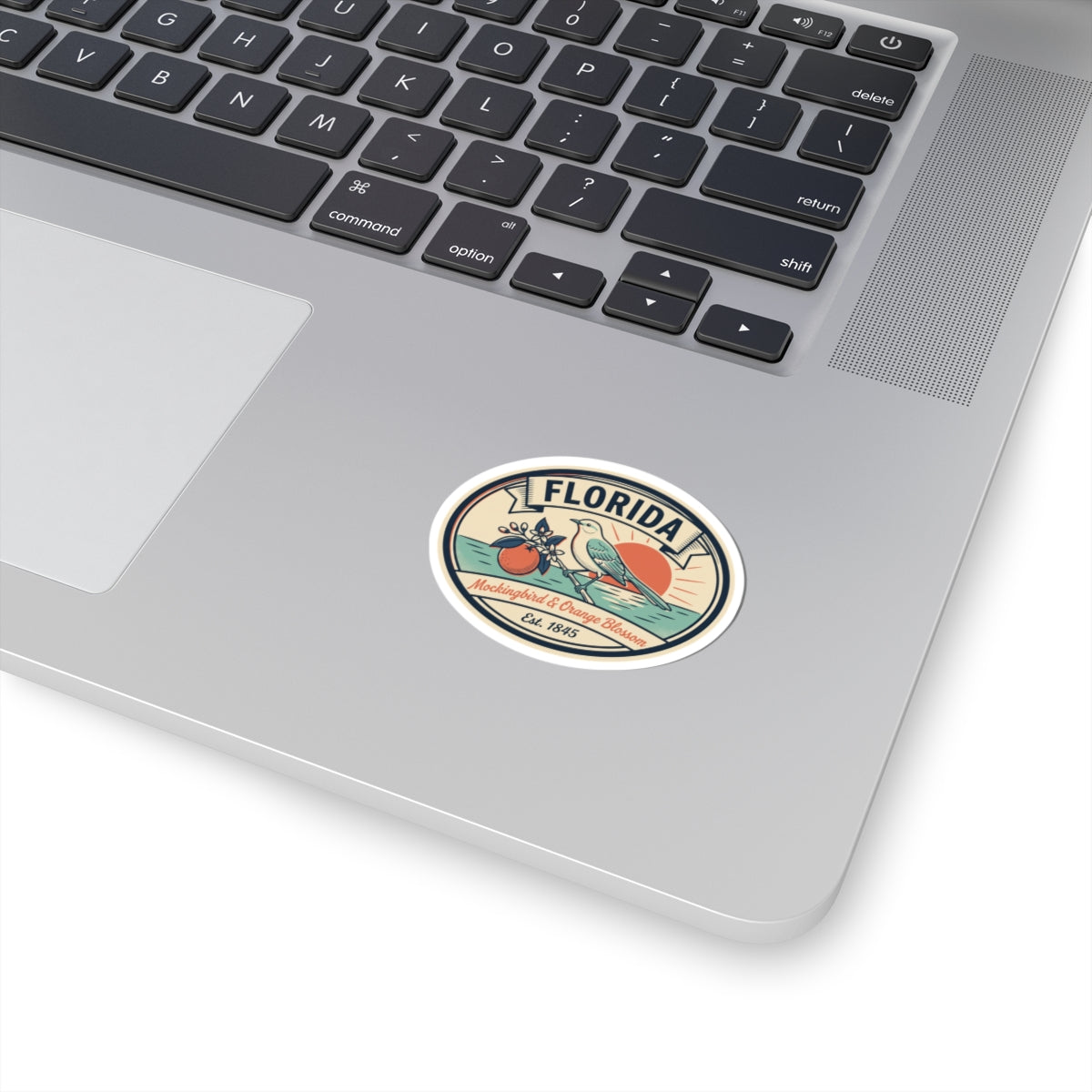 Round vintage Florida sticker with blue border, mockingbird and orange blossoms design.