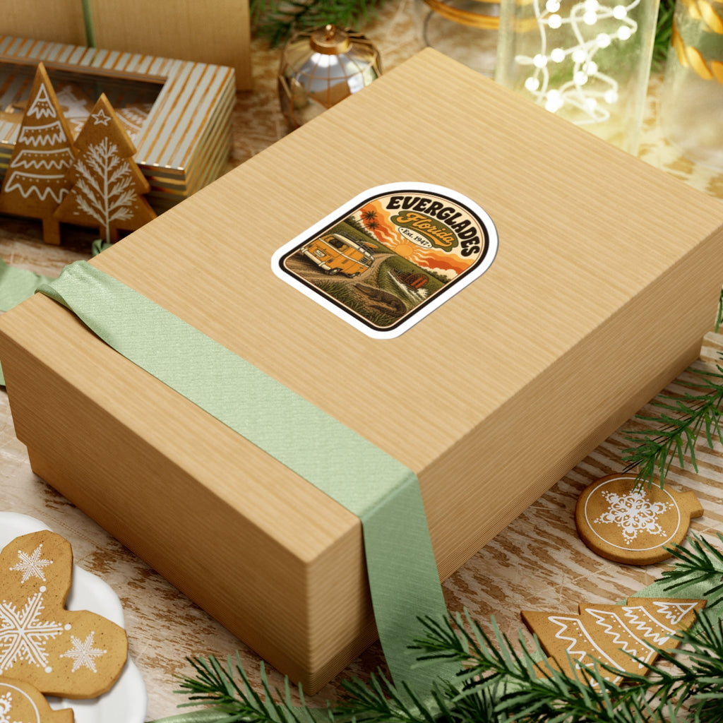 Everglades Florida vintage camper sticker on tan gift box, orange van and sunset artwork