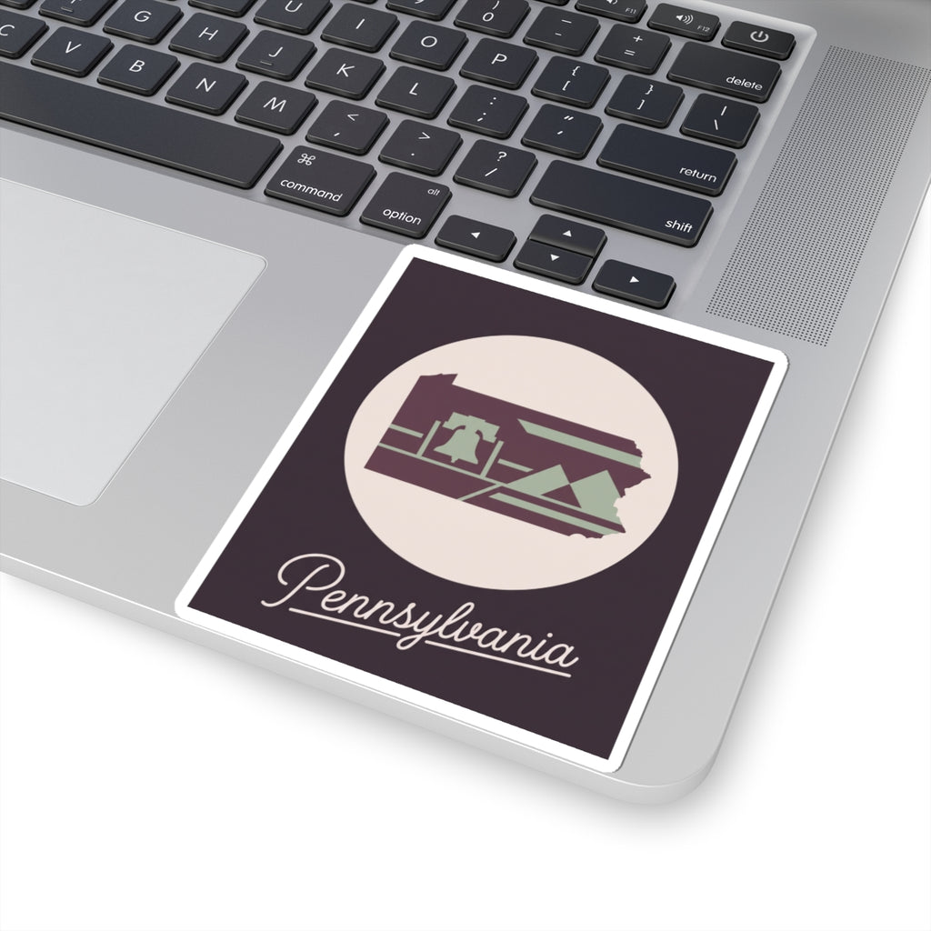 Pennsylvania state silhouette sticker on laptop lid, circular emblem with “Pennsylvania” script