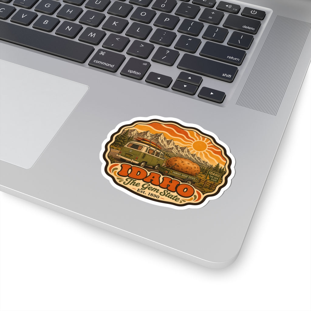 Idaho roadtrip sticker with green van and potato on orange mountain backdrop, white kiss-cut border.