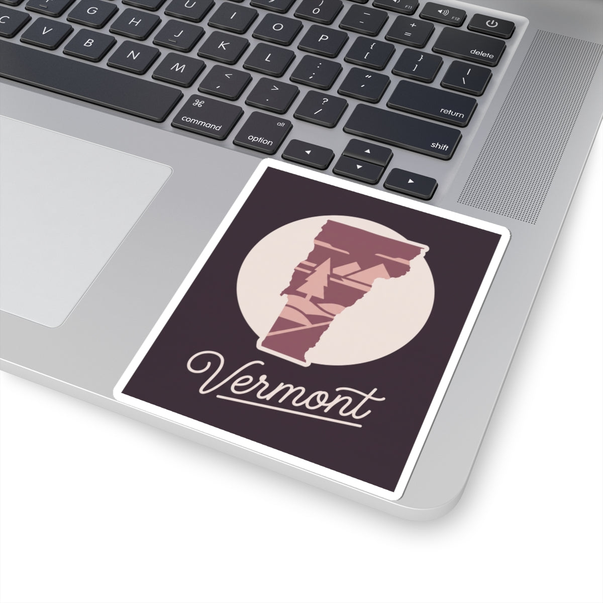 Vermont state silhouette sticker with maroon tree artwork and cursive 'Vermont' on dark square