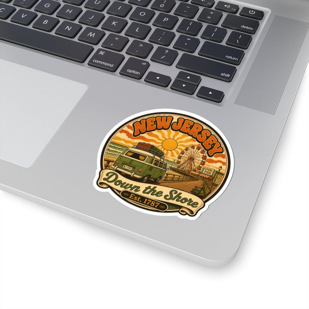 Round sticker placed on a laptop, showing New Jersey beach scene with van and ferris wheel.