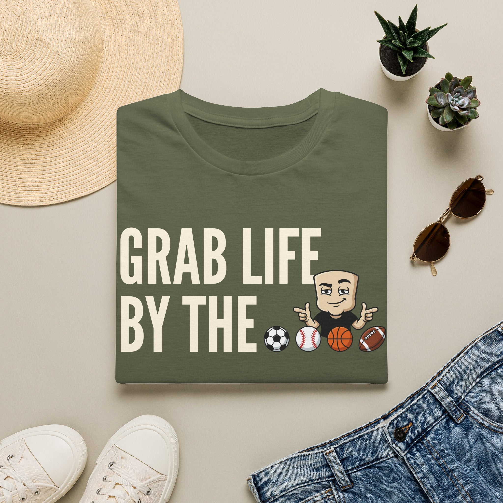 Green T-shirt with “GRAB LIFE BY THE” sports ball graphic and cartoon coach