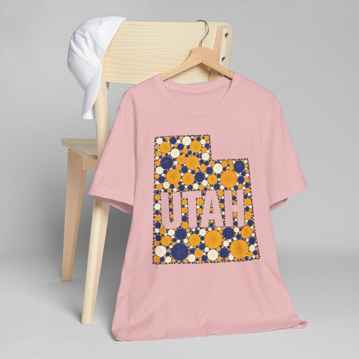 Dusty pink short-sleeve T-shirt with “UTAH” polka dot map graphic in blue and gold