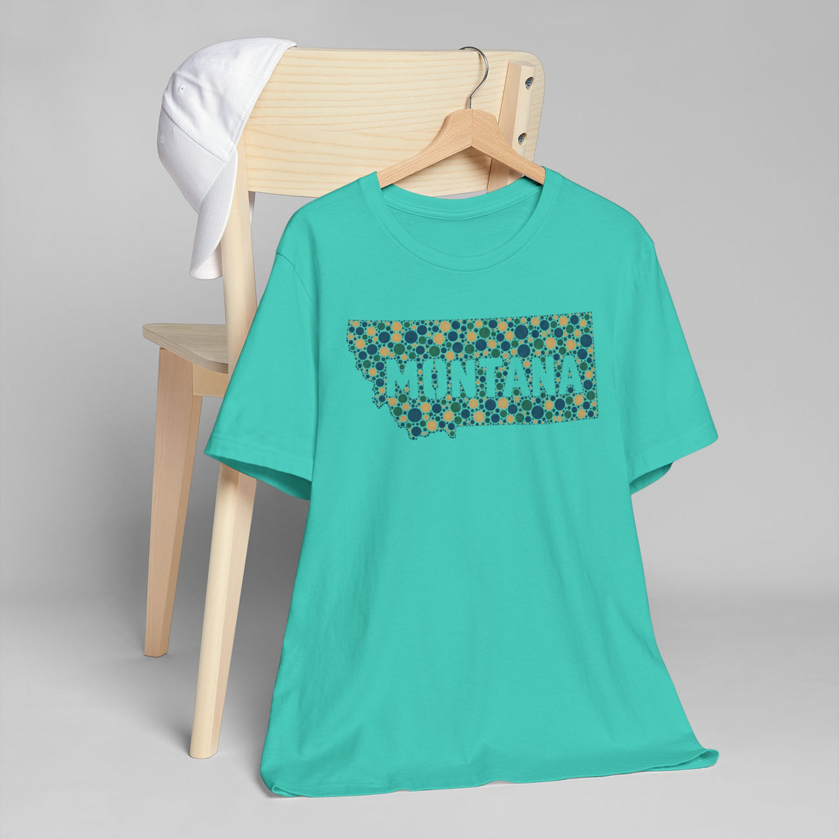 Teal T-shirt with colorful dotted Montana graphic across the chest.