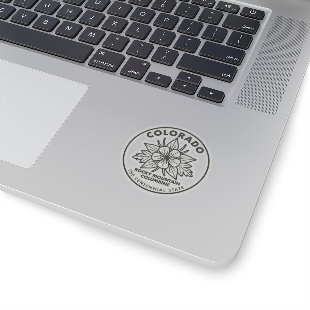 Columbine round sticker on a laptop lid, showing Colorado and state flower text