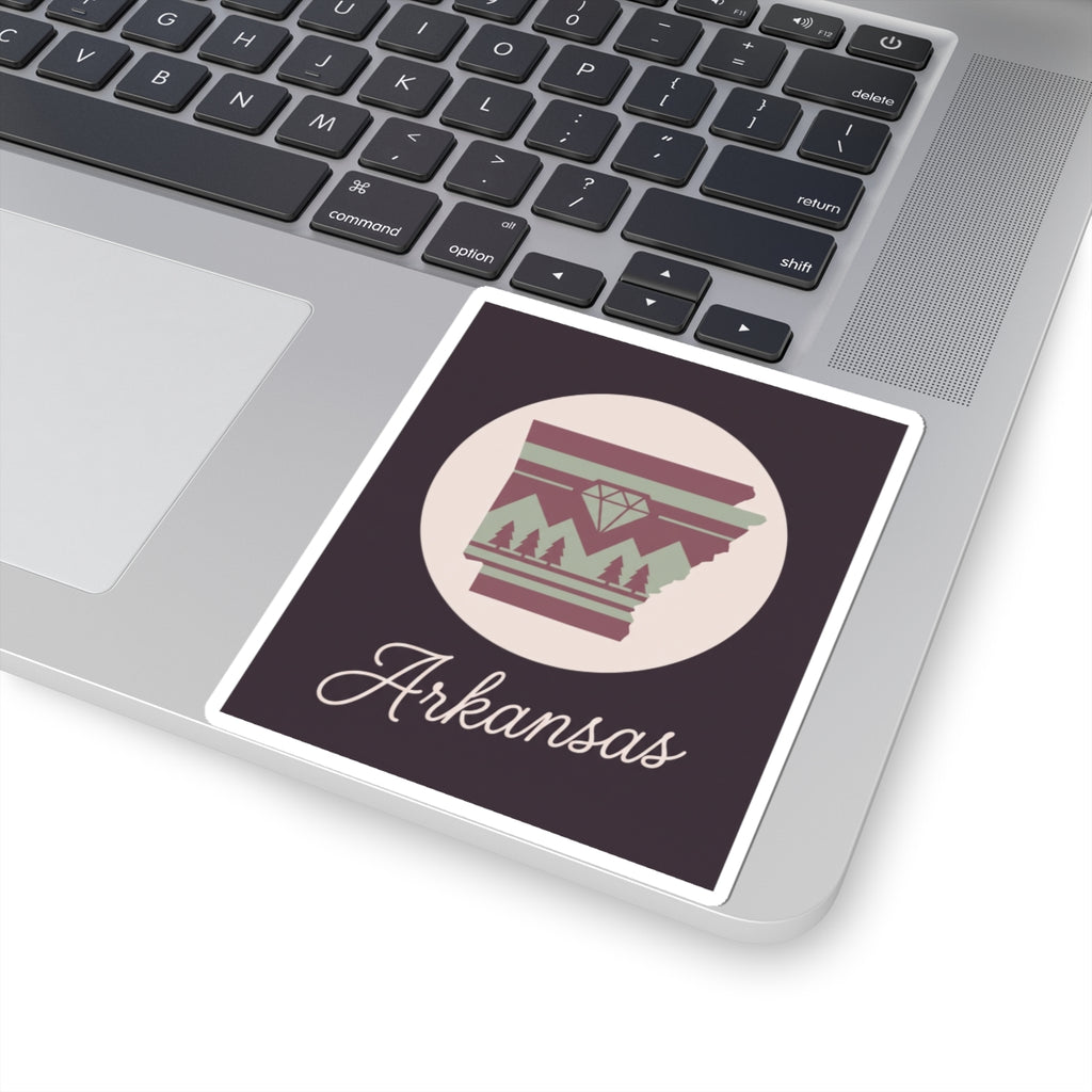 Arkansas vinyl sticker on laptop keyboard with circular emblem and white 'Arkansas' script
