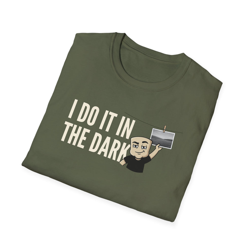 Olive green T-shirt with "I DO IT IN THE DARK" graphic and cartoon photographer