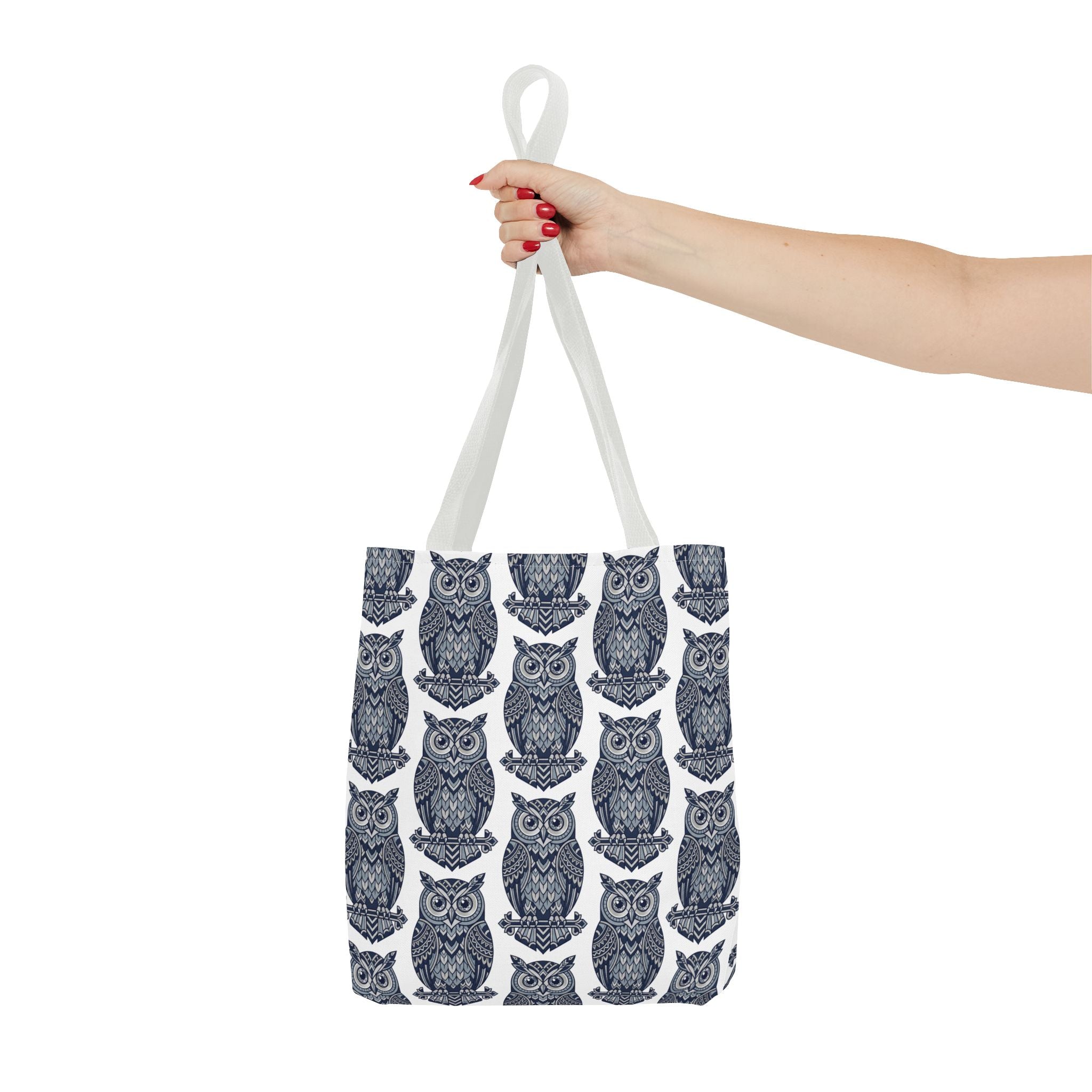 Tote bag with white handles and repeating navy owl pattern on white fabric