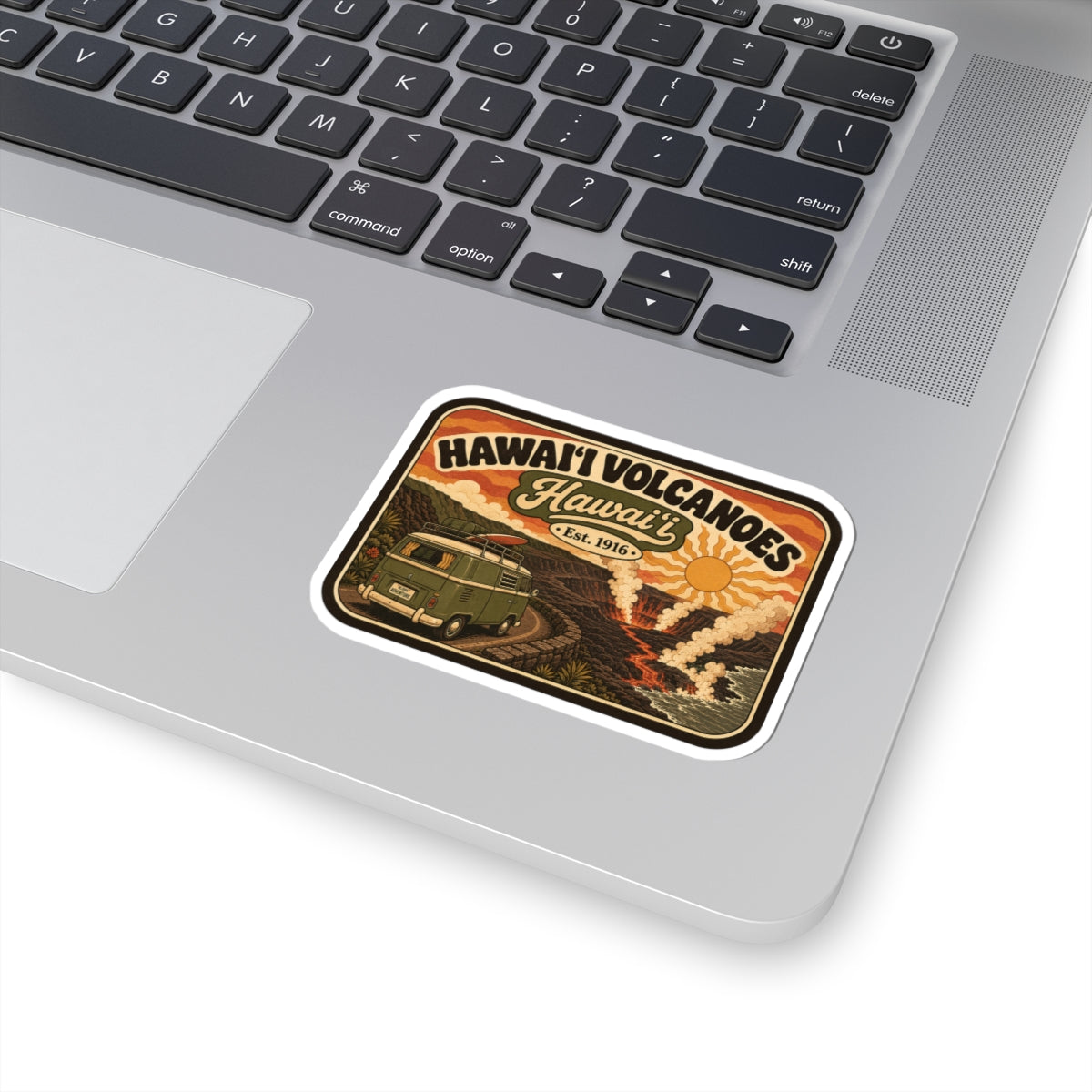 Kiss-cut travel sticker with retro Hawaii Volcanoes design on laptop keyboard