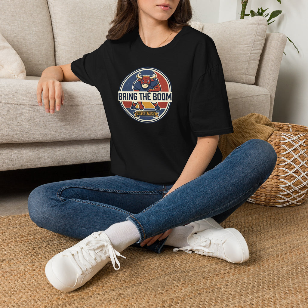 Black T-shirt worn by model, featuring circular bull mascot “BRING THE BOOM” chest graphic
