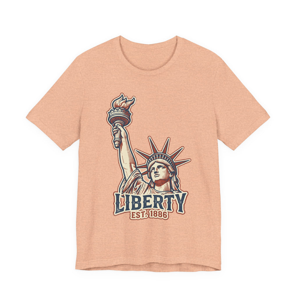 Heather peach crewneck graphic T-shirt with Statue of Liberty and “LIBERTY EST. 1886”