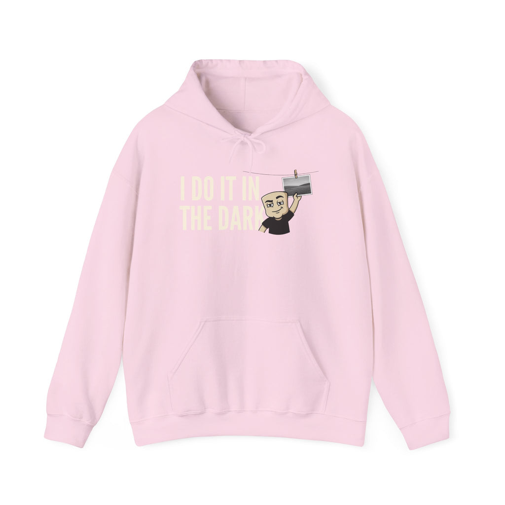 Pink hoodie with front kangaroo pocket, drawstring hood, and “I DO IT IN THE DARK” graphic