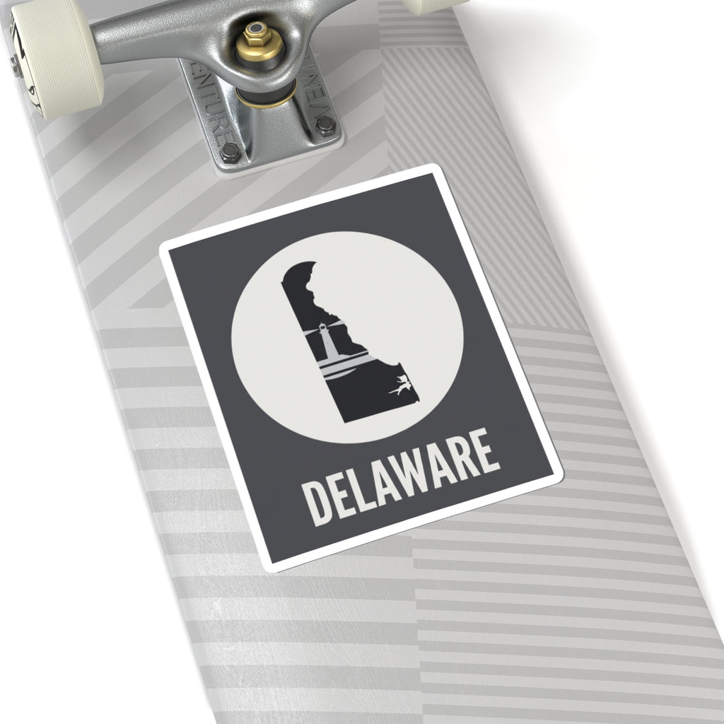 Delaware state silhouette vinyl decal on notebook, black badge with white circle and DELAWARE