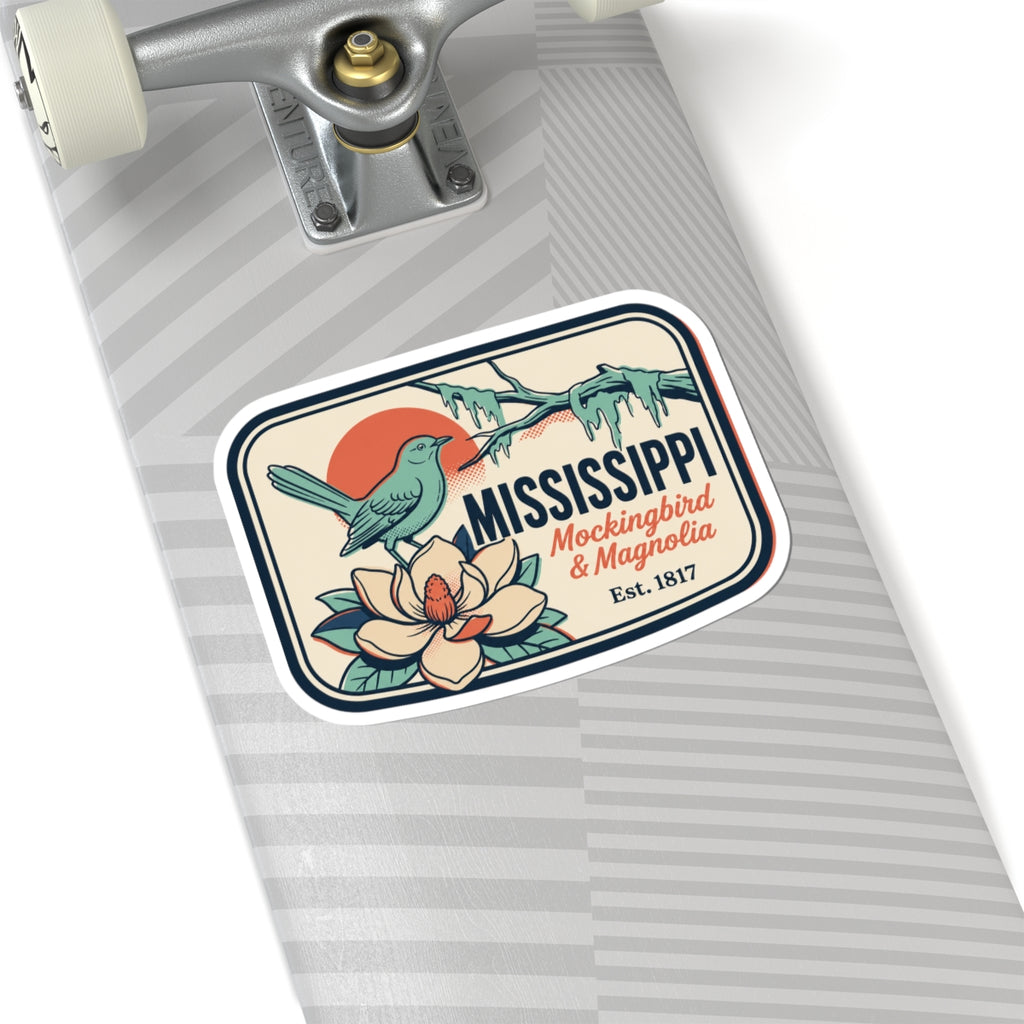 Mississippi state vinyl sticker on a gray striped notebook page, bird and flower badge