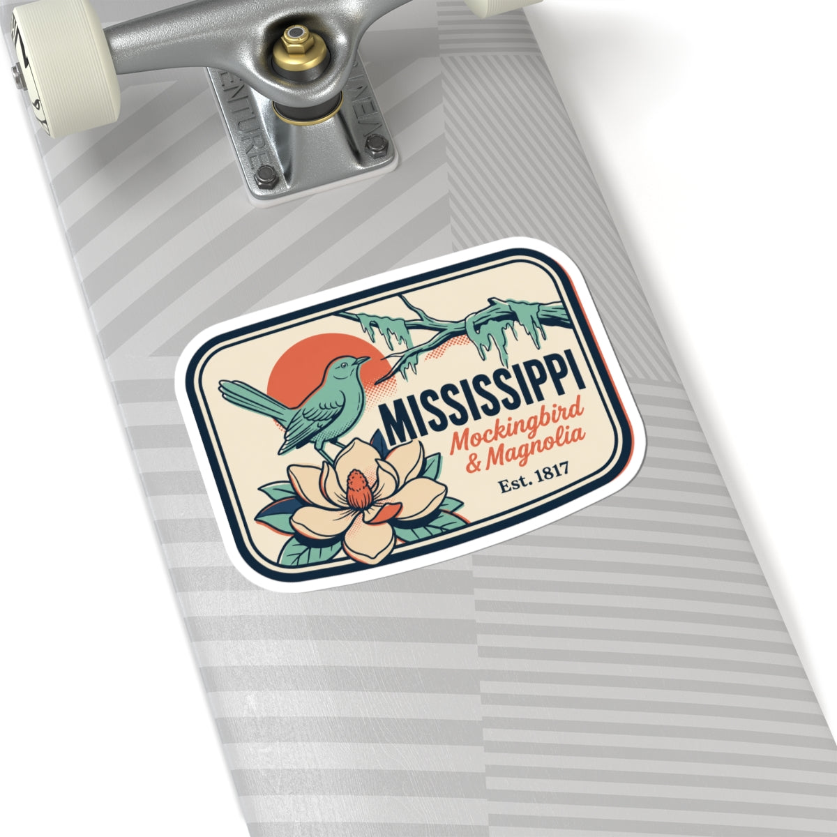 Mississippi state vinyl sticker on a gray striped notebook page, bird and flower badge