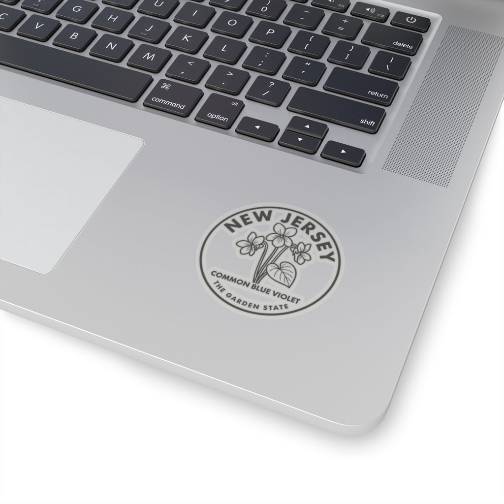 Transparent vinyl sticker of New Jersey common blue violet placed on a laptop lid
