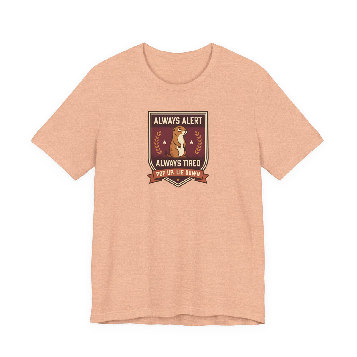 Peach T-shirt with squirrel crest badge graphic and “Always Alert Always Tired” text