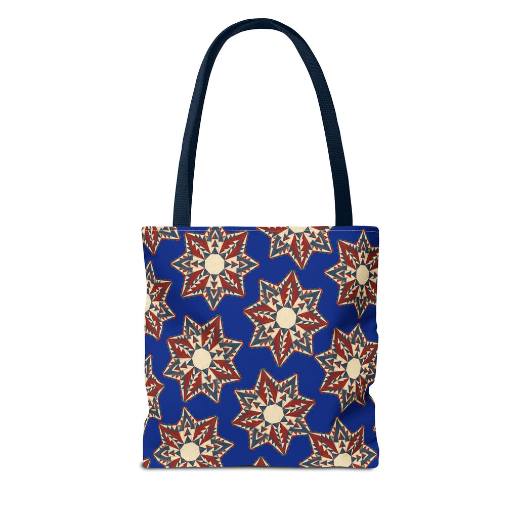 Blue tote bag with repeating red and cream starburst floral pattern and tall handles.