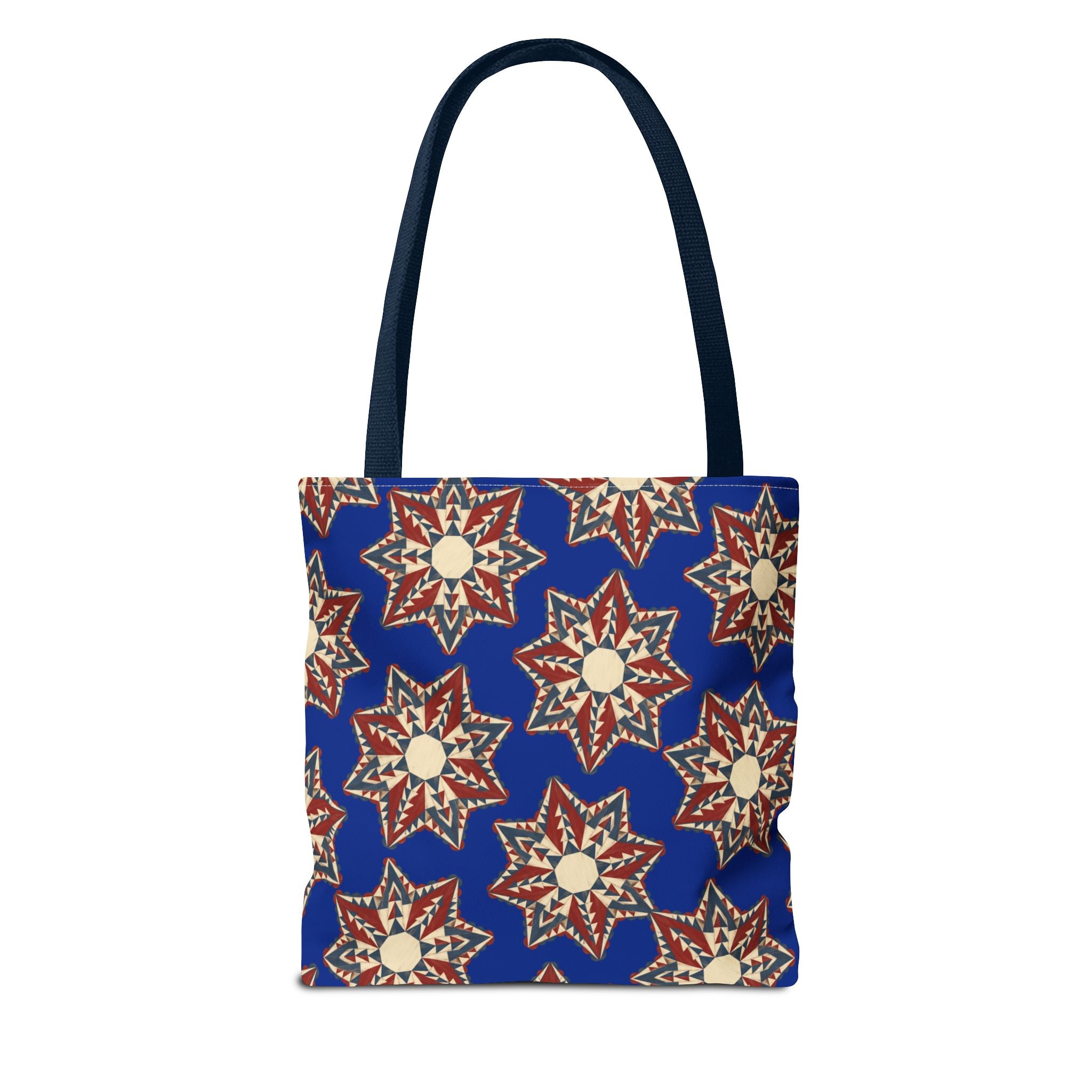Blue tote bag with repeating red and cream starburst floral pattern and tall handles.