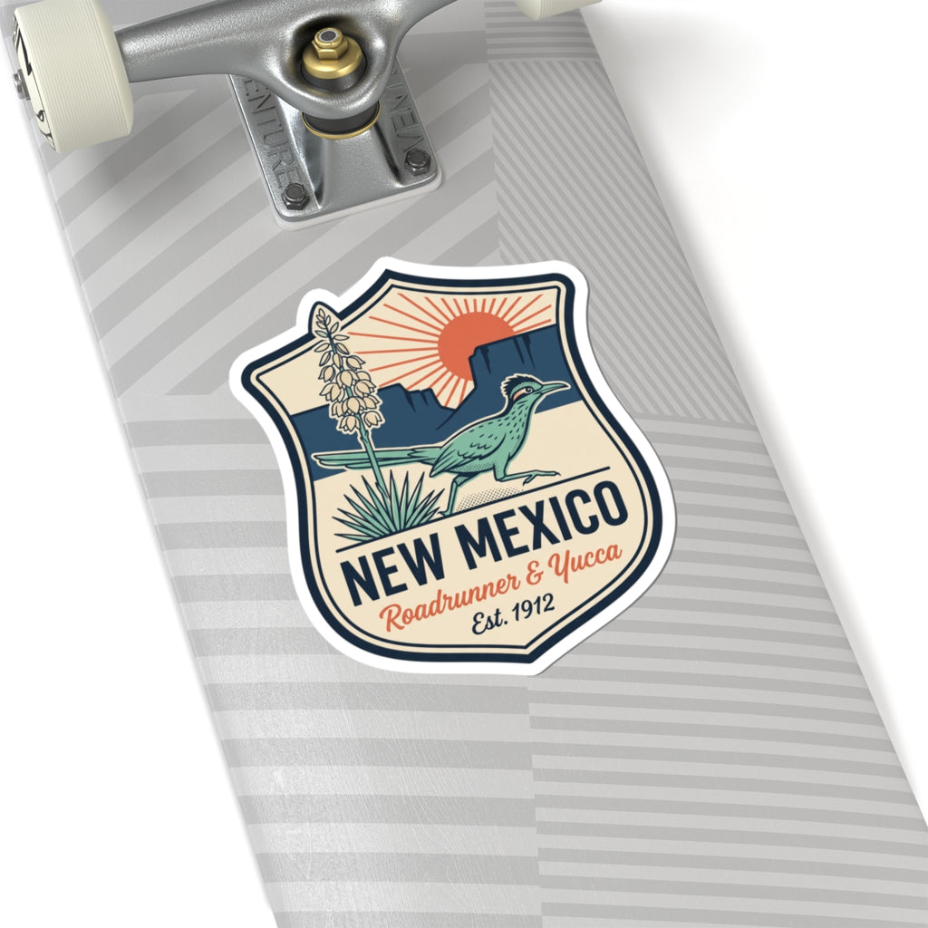Shield-shaped vinyl decal on a clipboard: roadrunner, yucca plant, and “NEW MEXICO”