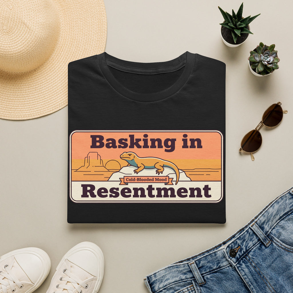 Black lizard graphic T-shirt with retro desert print: “Basking in Resentment”.