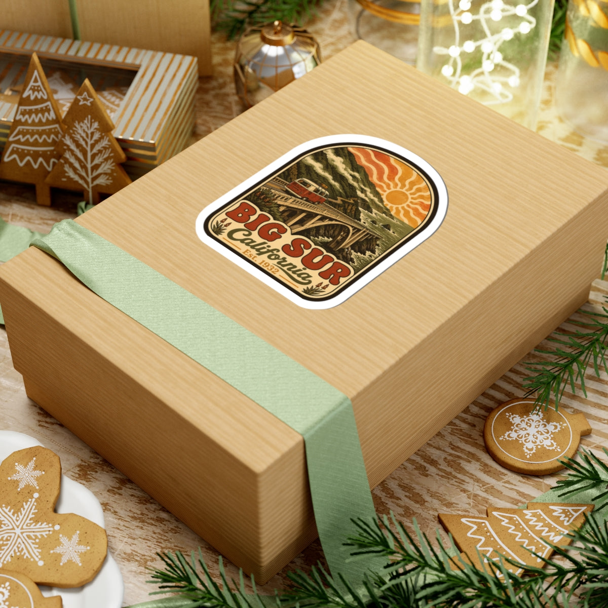 Kiss-cut Big Sur California sticker on wrapped gift box, vintage bridge and camper van design.