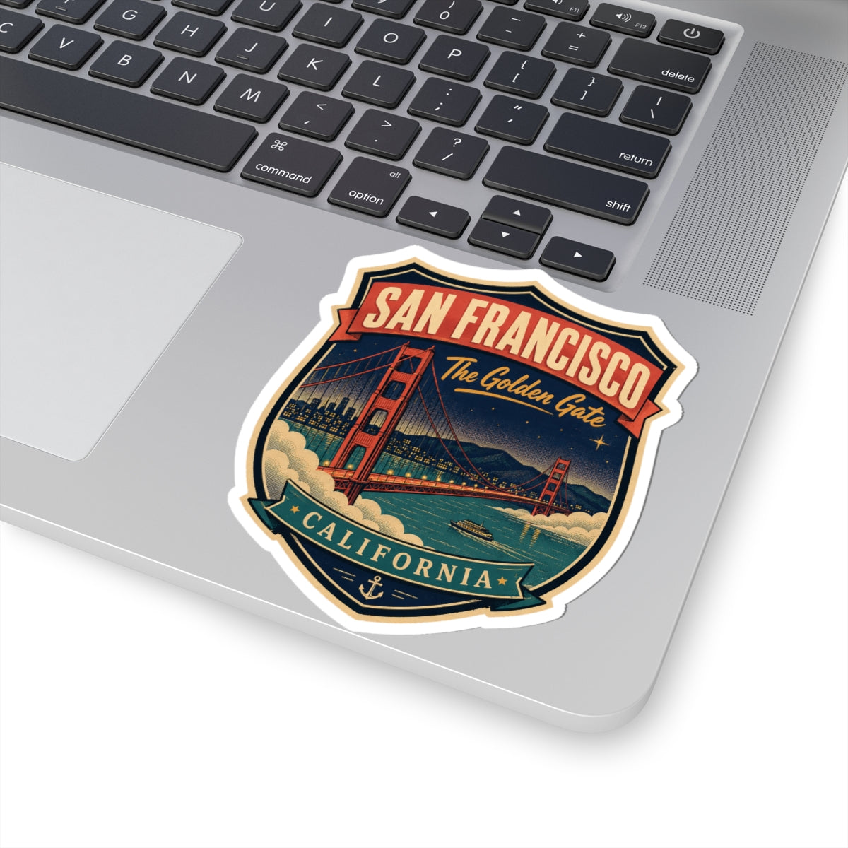 Luggage tag sticker on laptop lid: San Francisco crest with Golden Gate Bridge and California