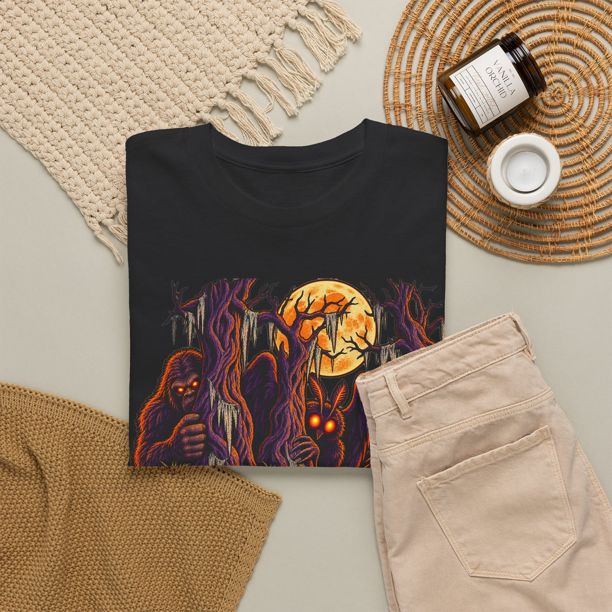 Black Halloween monster graphic T-shirt with haunted forest and glowing pumpkin face.