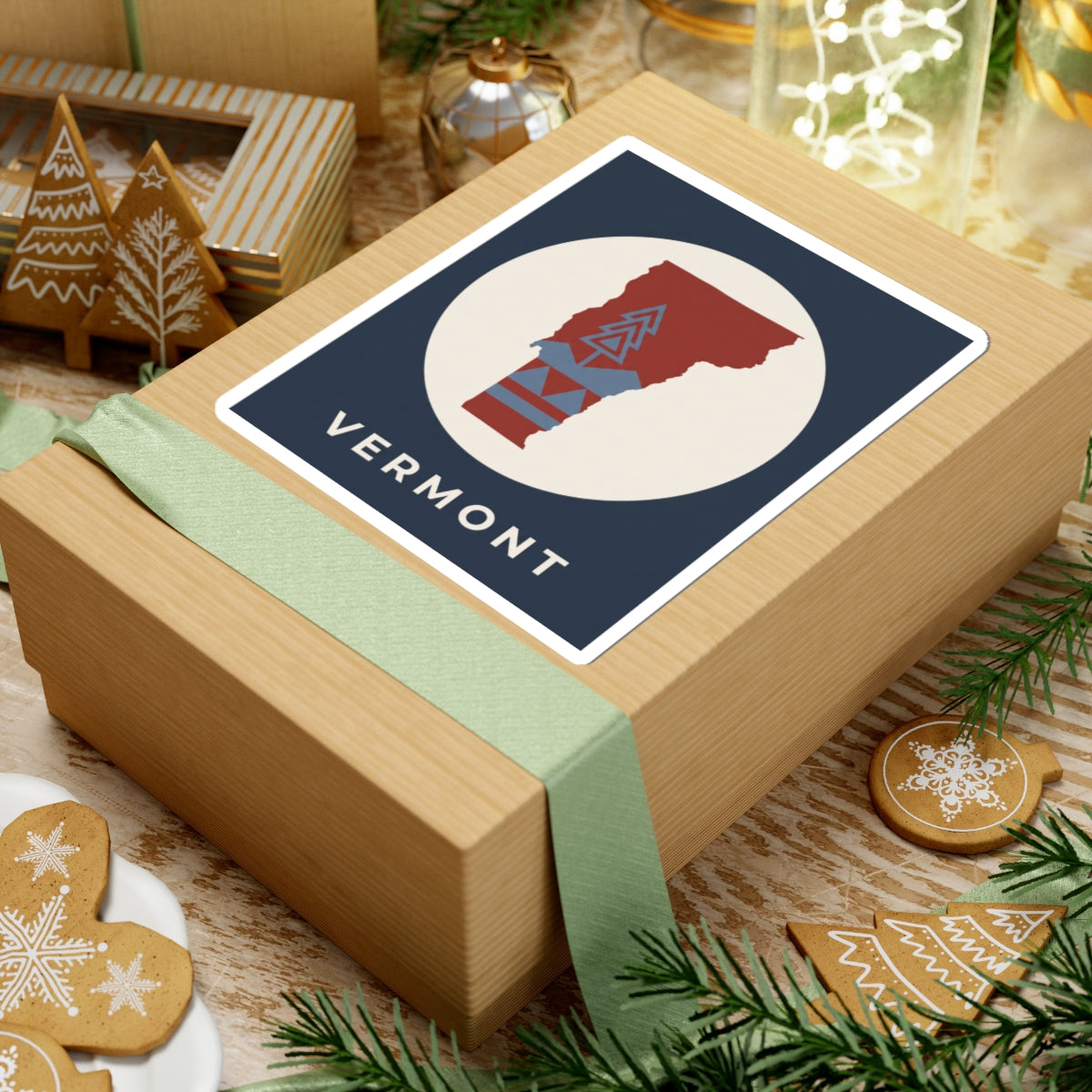 Vermont map sticker label with red Vermont silhouette, blue retro mountain pattern, 'VERMONT' text
