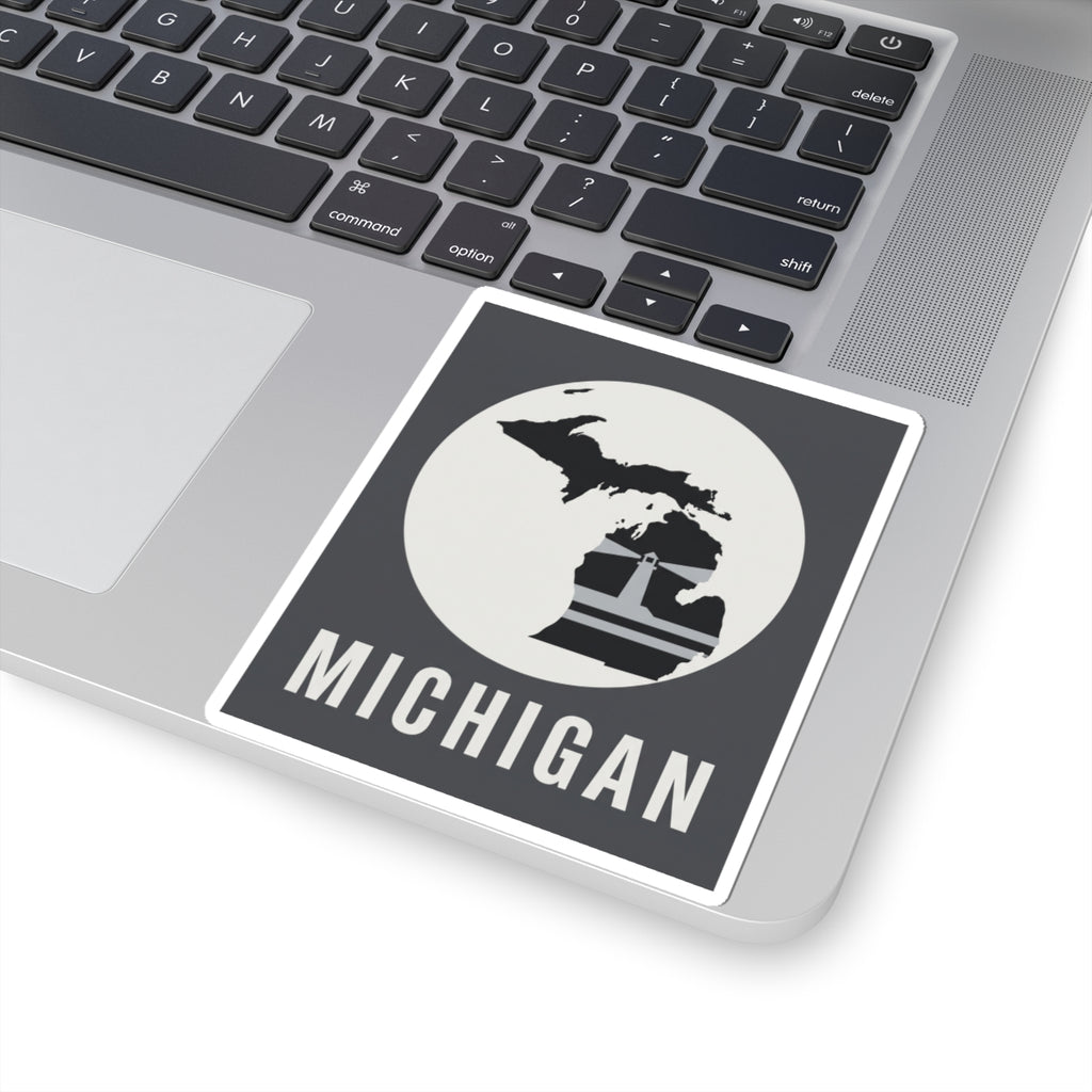 Square Michigan decal on a laptop, black silhouette with lighthouse and “MICHIGAN” word.