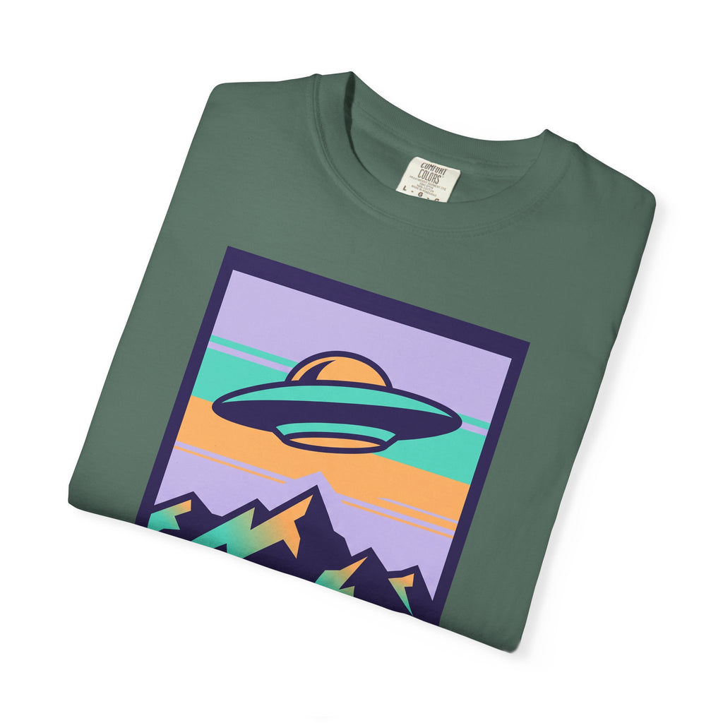 Dark green T-shirt with square UFO and mountains graphic on front.