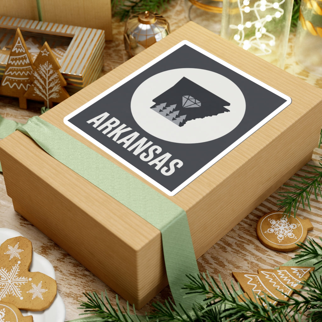 Arkansas vinyl sticker on gift wrap: dark state silhouette, diamond tree graphic, ARKANSAS