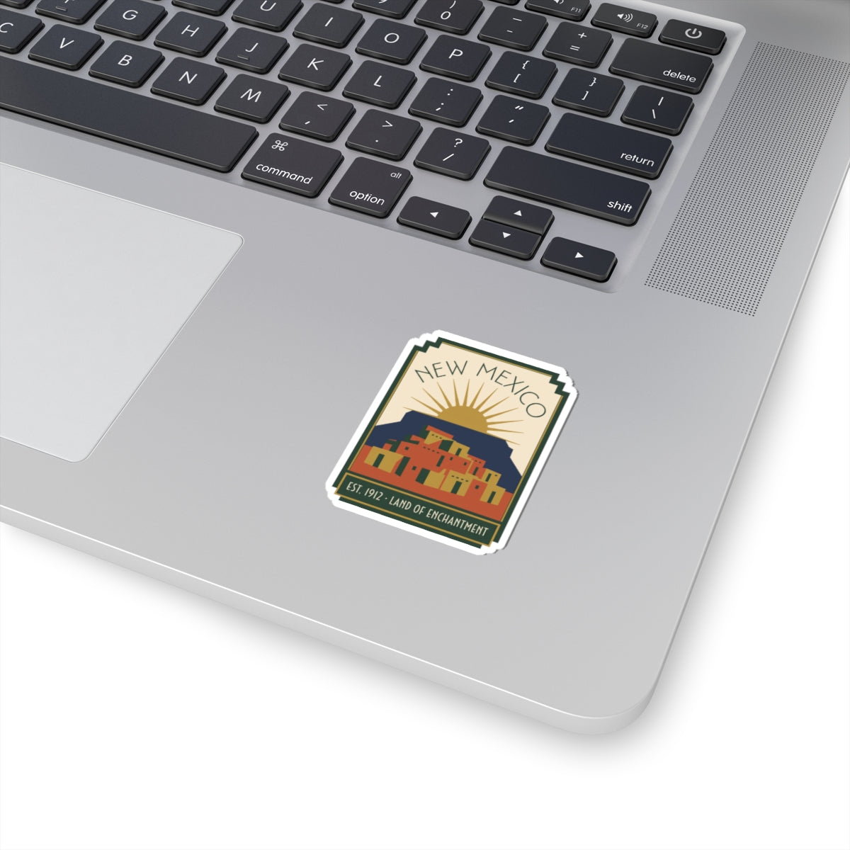 Kiss-cut vinyl New Mexico emblem sticker with white border and pueblo style artwork