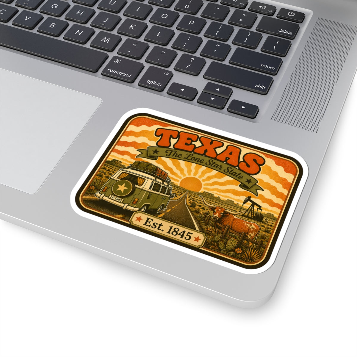 Kiss-cut Texas road trip sticker on laptop keyboard