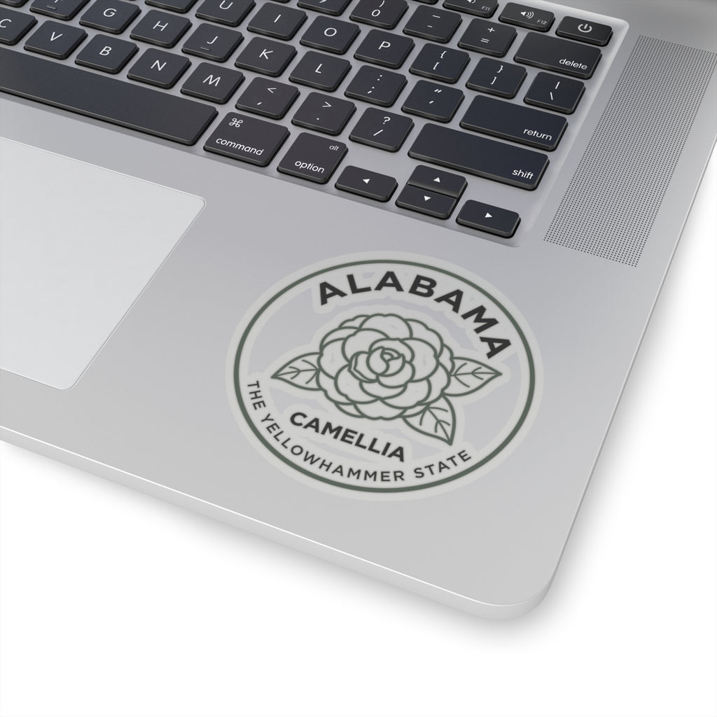 Round Alabama camellia state sticker on silver laptop trackpad area