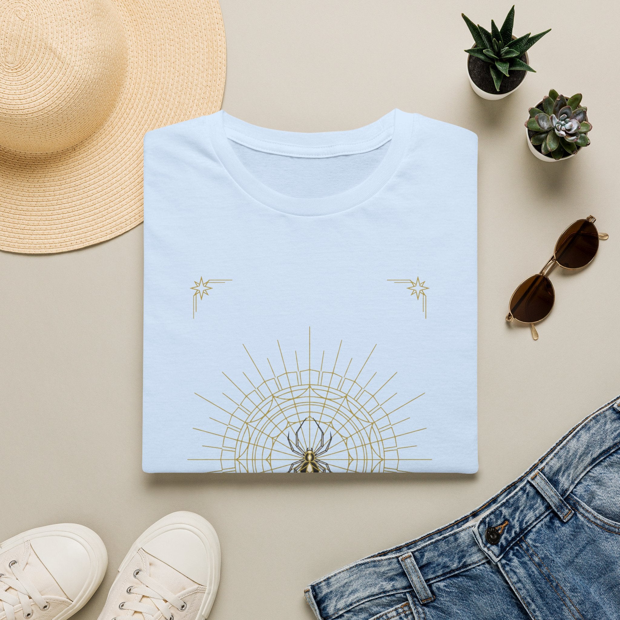 Light blue T-shirt with light gold spider mandala web and star accents graphic