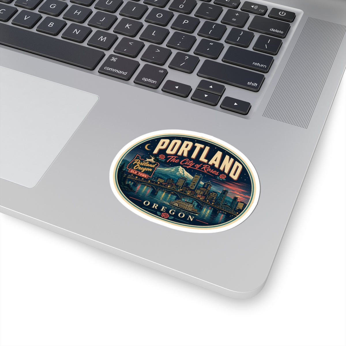 Round Portland Oregon luggage tag sticker on laptop keyboard with retro city skyline design